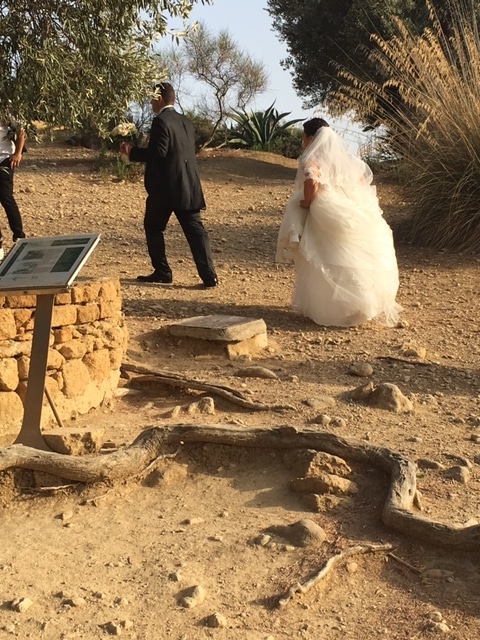 Bride and Groom at Temple of Hera running to have their photo taken