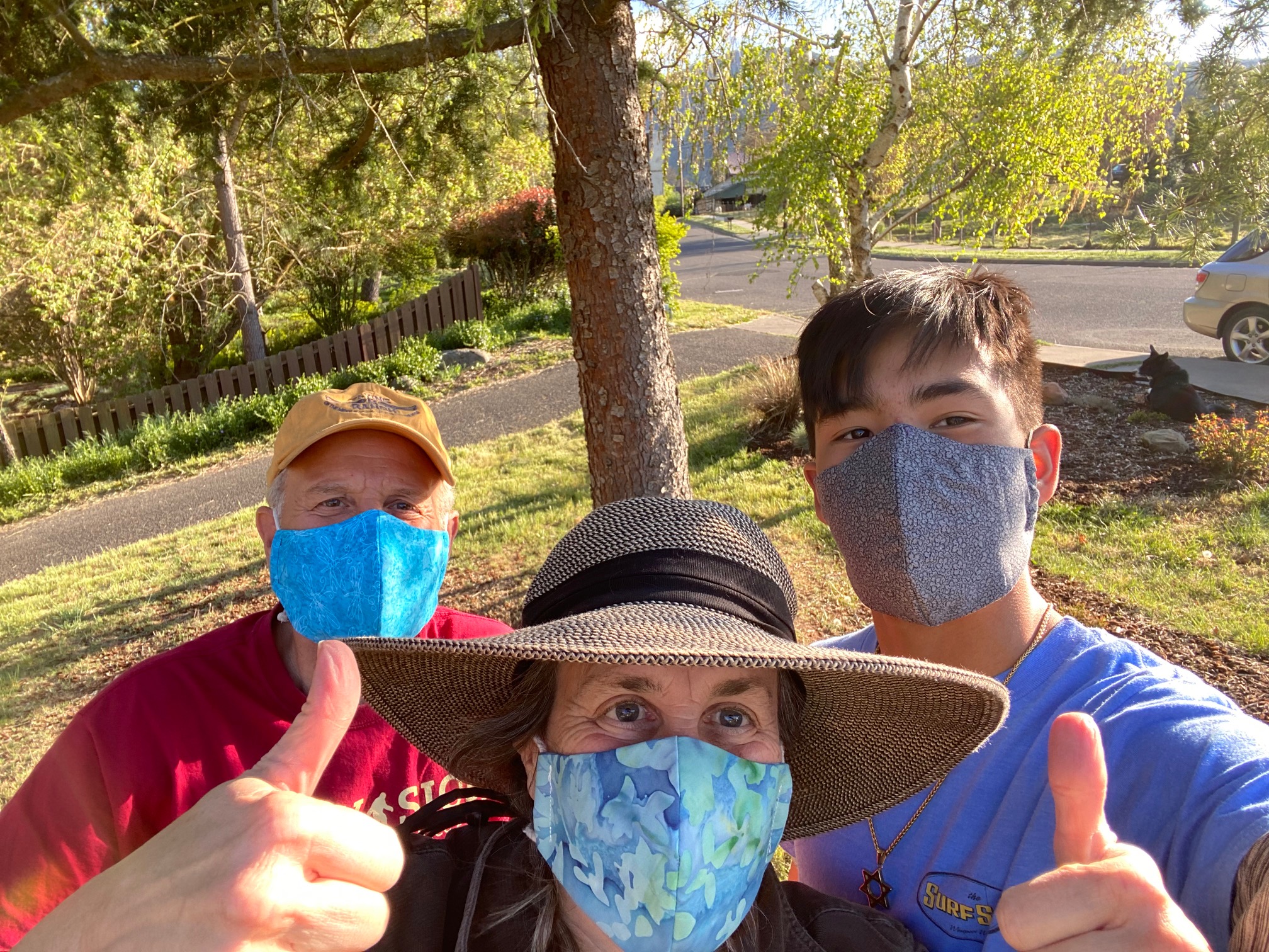 Laura Robin, Ari Bandoroff and Scott Bandoroff wearing Jeanne Robin's masks