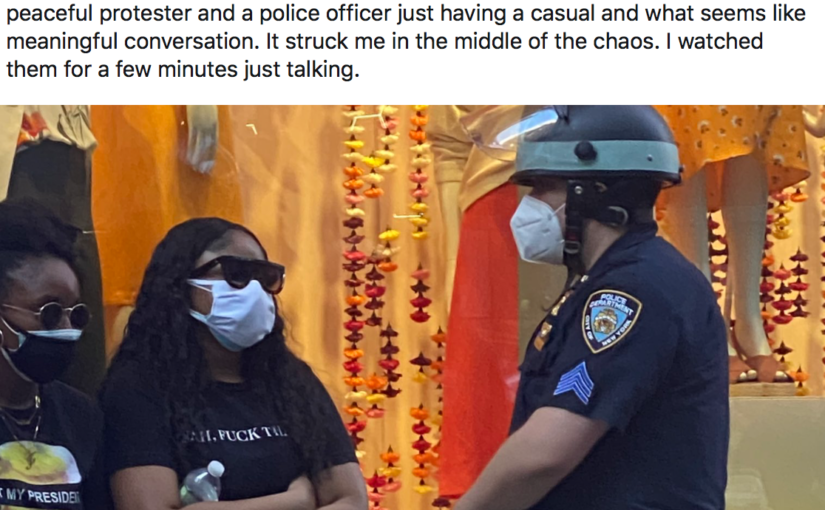 Tweet showing a protestor talking to an NYPD officer
