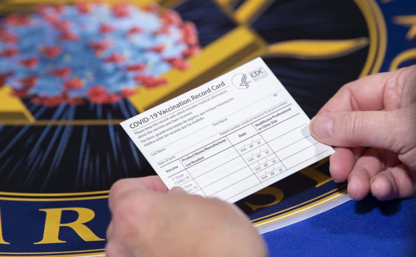 A Department of Health and Human Services employee holds a COVID-19 vaccine record card Nov. 13, 2020, in Washington D.C. The cards will be sent out as part of vaccination kits from Operation Warp Speed, which is an effort by several U.S. government components and public partnerships to facilitate the development, manufacturing and distribution of COVID-19 vaccines, therapeutics and diagnostics. (DoD photo by EJ Hersom)