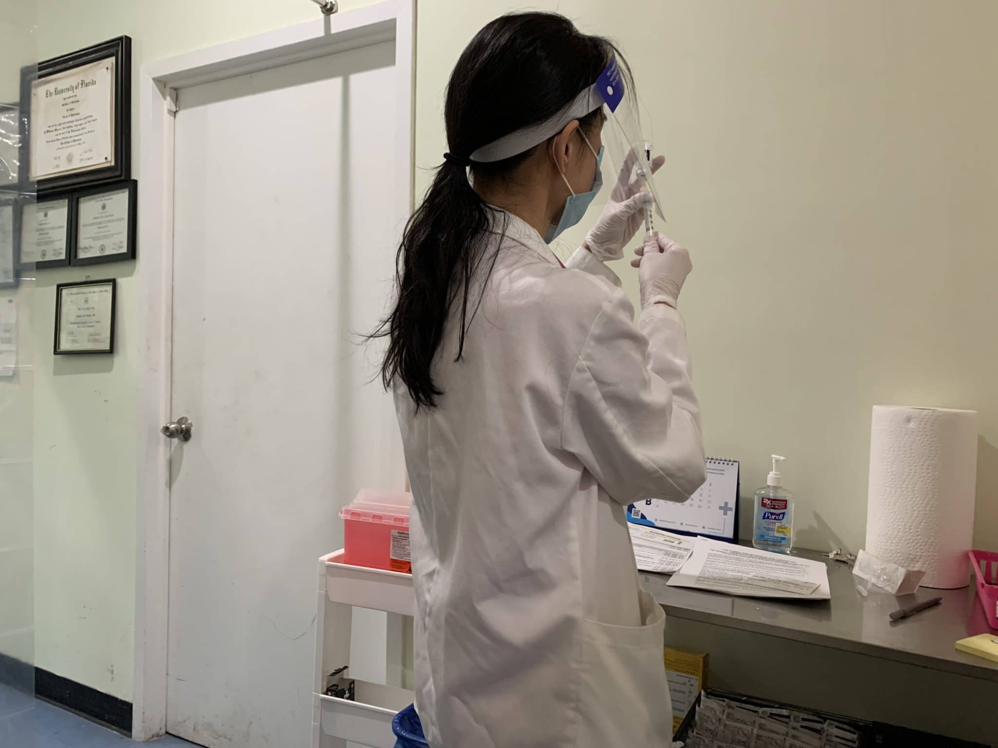 Mia Yu preparing the COVID-19 Vaccine for injection at the Rossi Pharmacy. Photo by ConsumerMojo.com