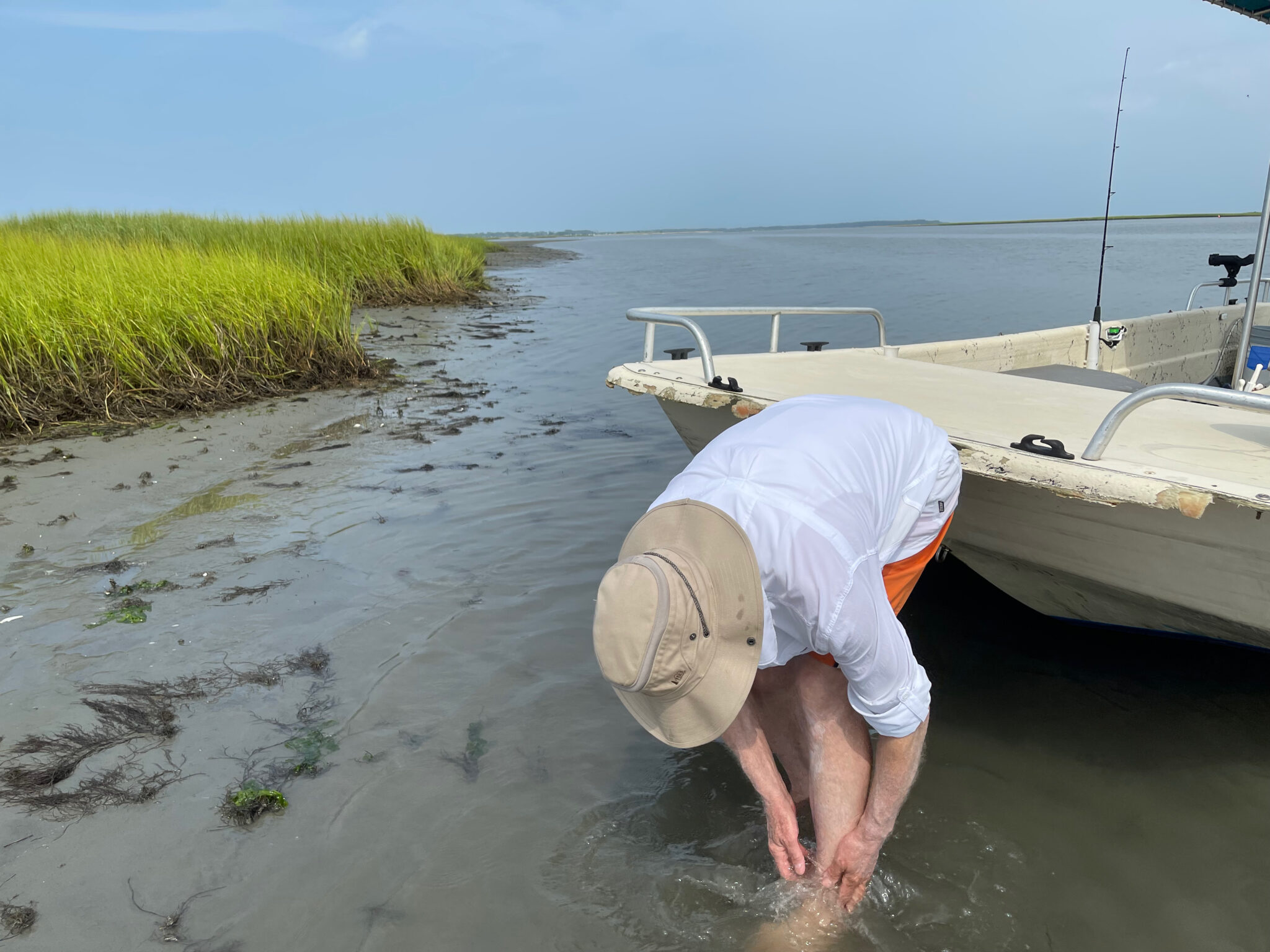 Nick Taylor washing the mud off after clamming at Tom's Cove, Chincoteague, Virginia
