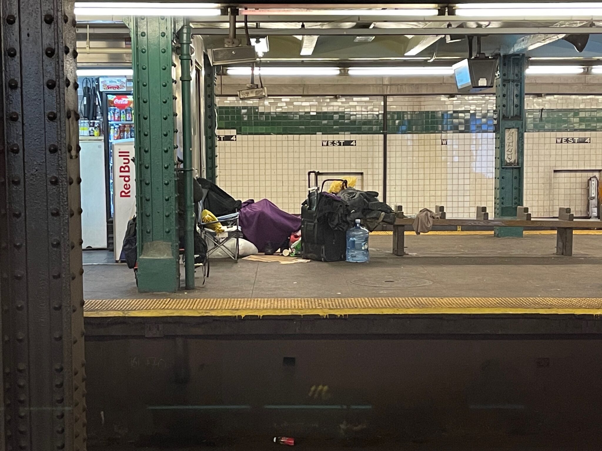 Homeless Person Camped out in the subway. Photo by ConsumerMojo.com