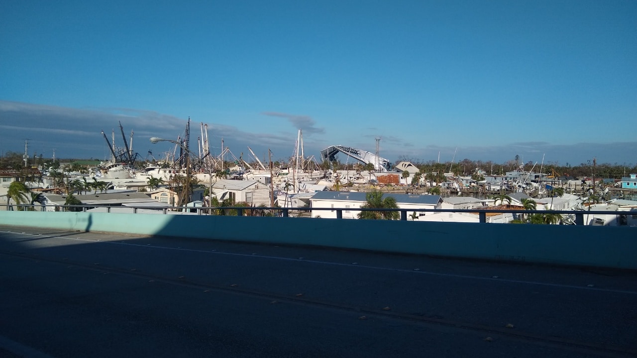 Damaged boats and causeway in the distance.