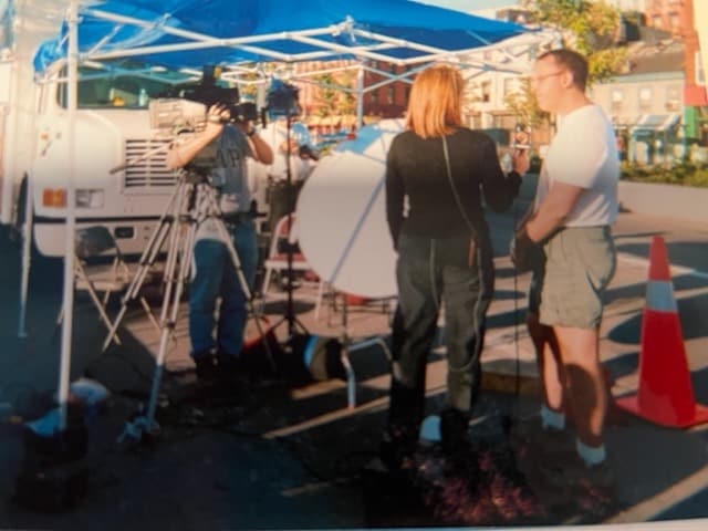 Over the shoulder shot of Barbara Nevins Taylor interviewing a man after 9/11