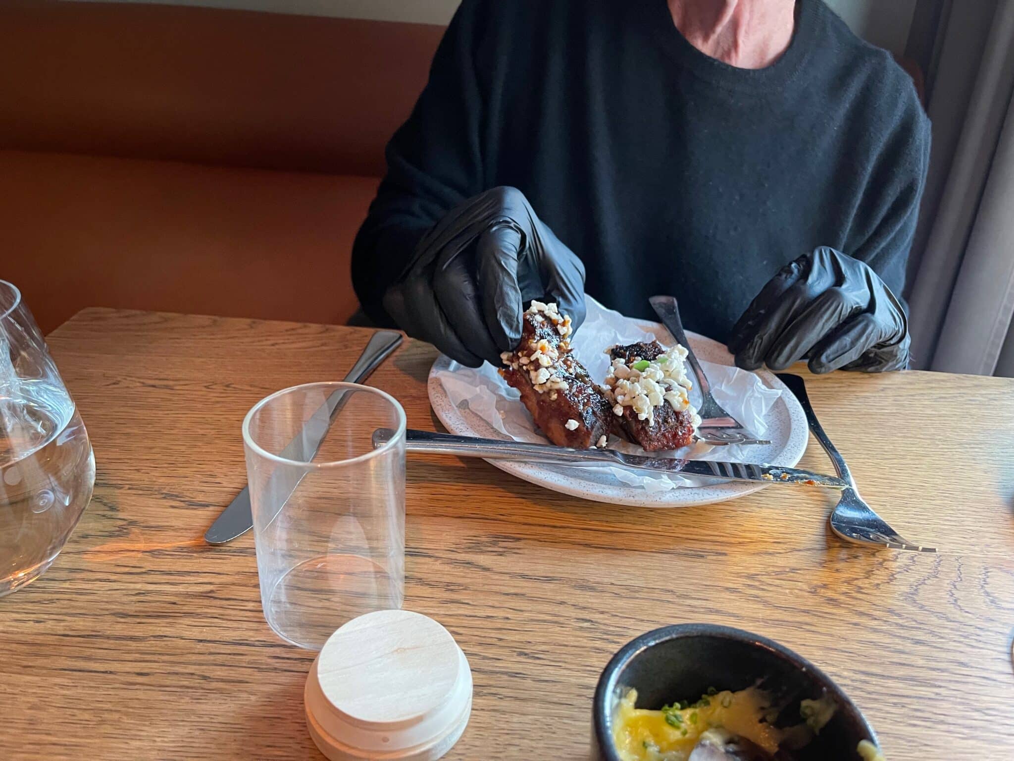 Nick Taylor was given rubber gloves to eat messy ribs.