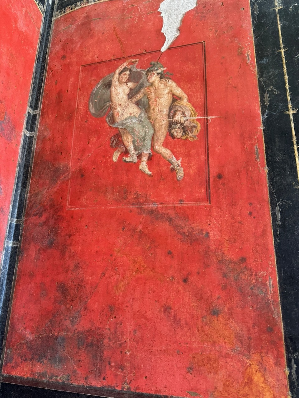 Cupids on red painted walls. Photo by ConsumerMojo.com