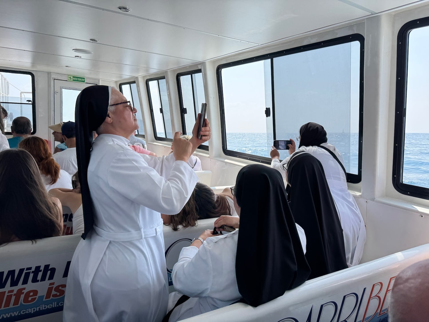 Nuns taking photos on the boat on the boat to the Amalfi Coast. Photo by ConsumerMojo.com