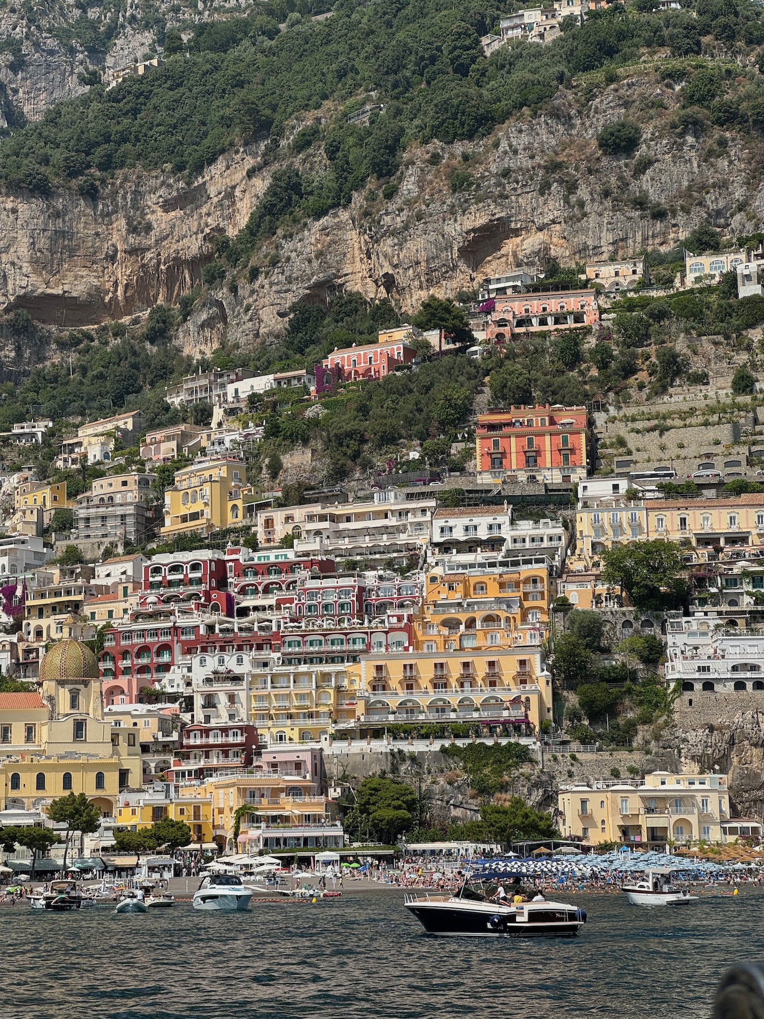 Positano  from the boat with small craft and beach. Photo by ConsumerMojo.com