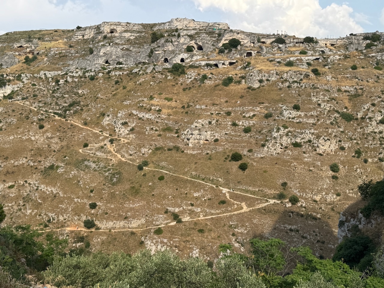 Road leading up to the caves across the way. Crosses on top of the mountain. Photo by ConsumerMojo.com