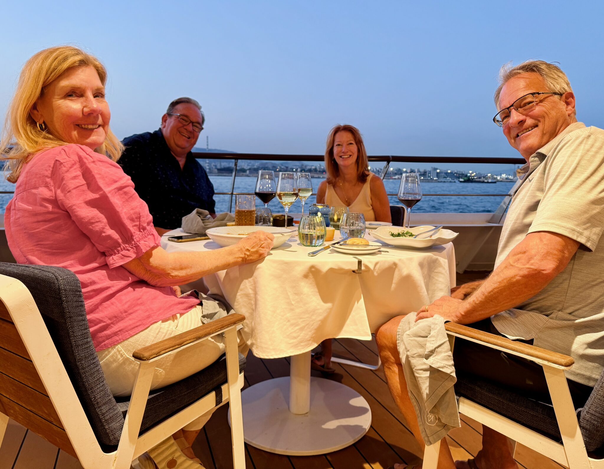 Two couples enjoying dinner on the stern of the Atlas World Traveller