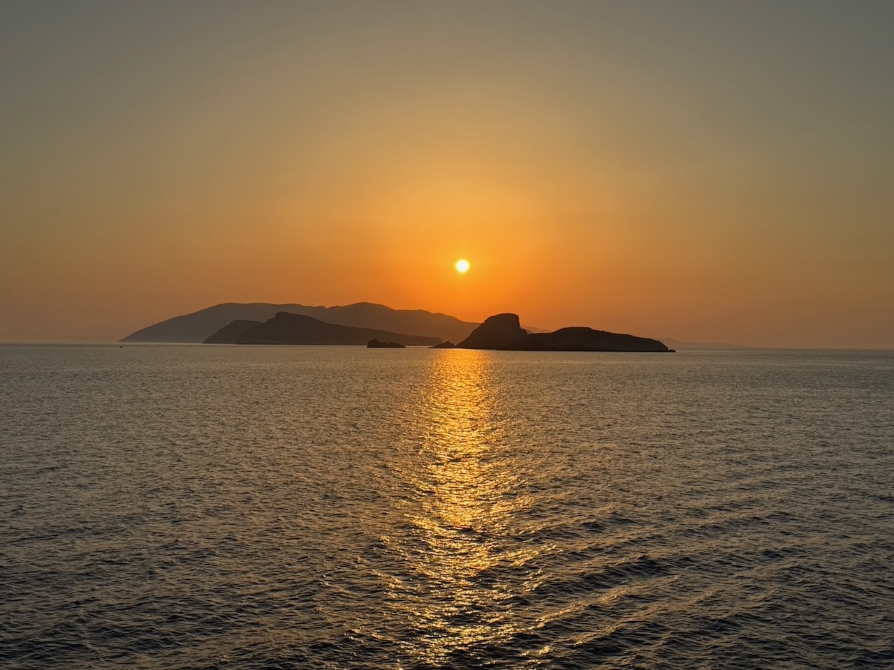 Horizontal sunrise over Folegandros. Photo by ConsumerMojo.com