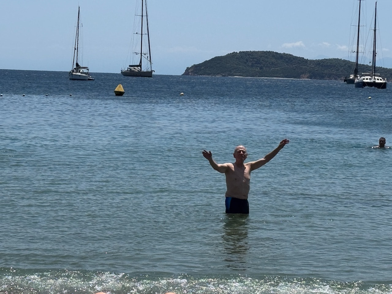 Nick Taylor with arms up in the Aegaen at Magli Amos, Skiathos, Greece. Photo by ConsumerMojo.com