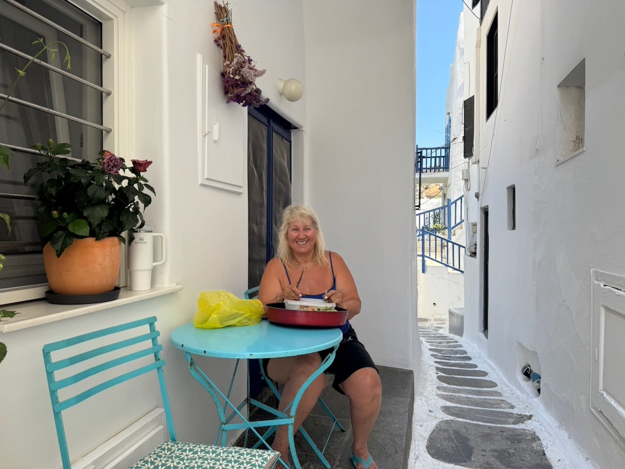 Mariana shelling okra in front of her house on Mykonos. Photo by ConsumerMojo.com