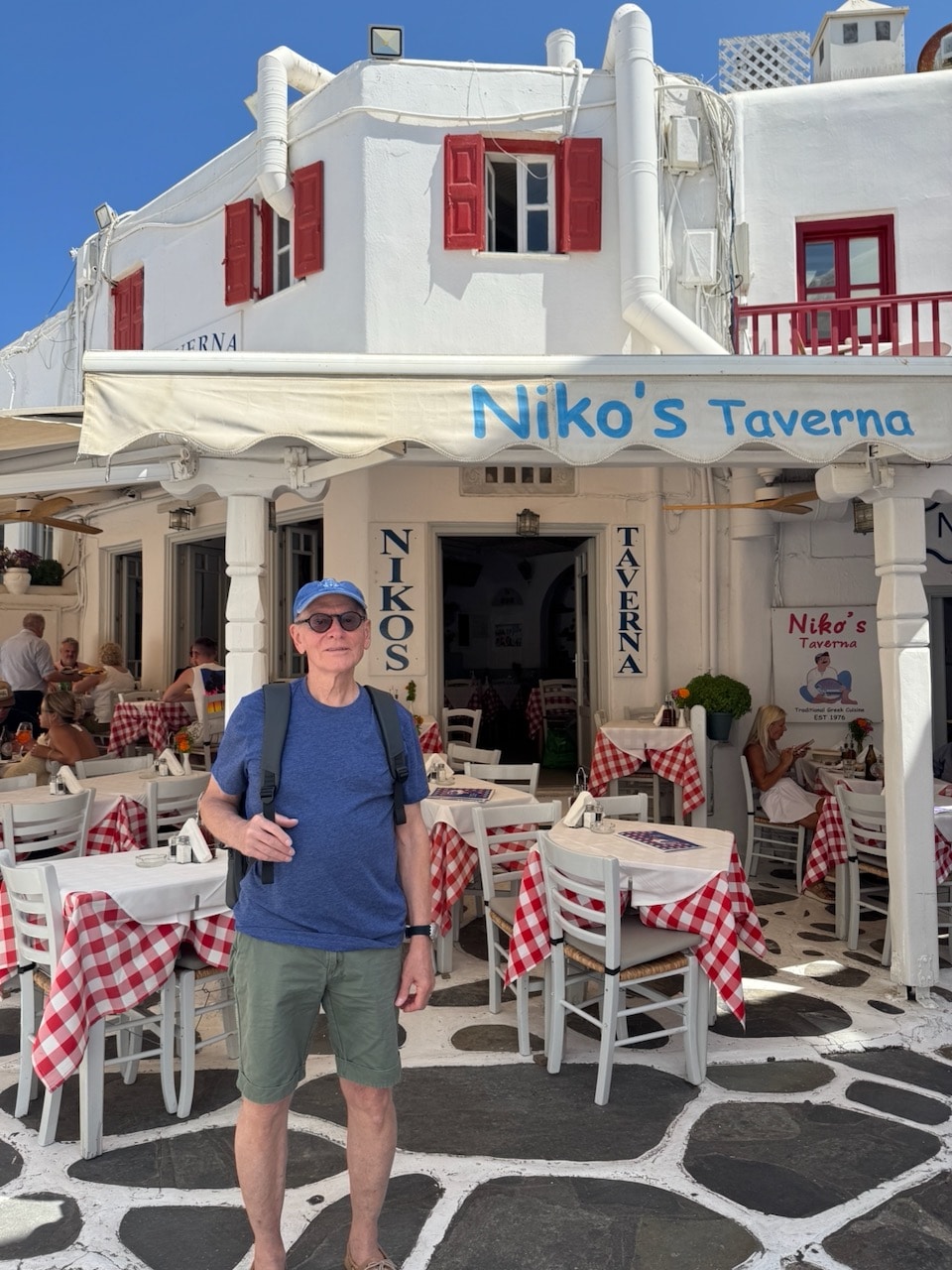 Nick in front of Nikos Taverna on Mykonos. Photo by ConsumerMojo.com