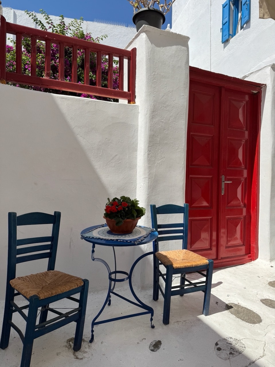 Picture pretty door and chairs. Mykonos. Photo by ConsumerMojo.com